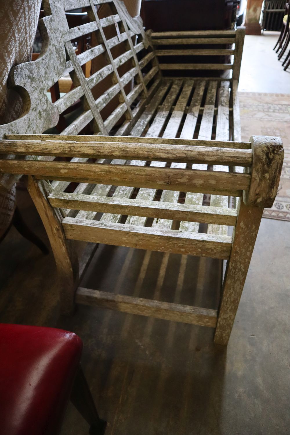 A Lutyens-style weathered teak garden bench, width 170cm height 106cm